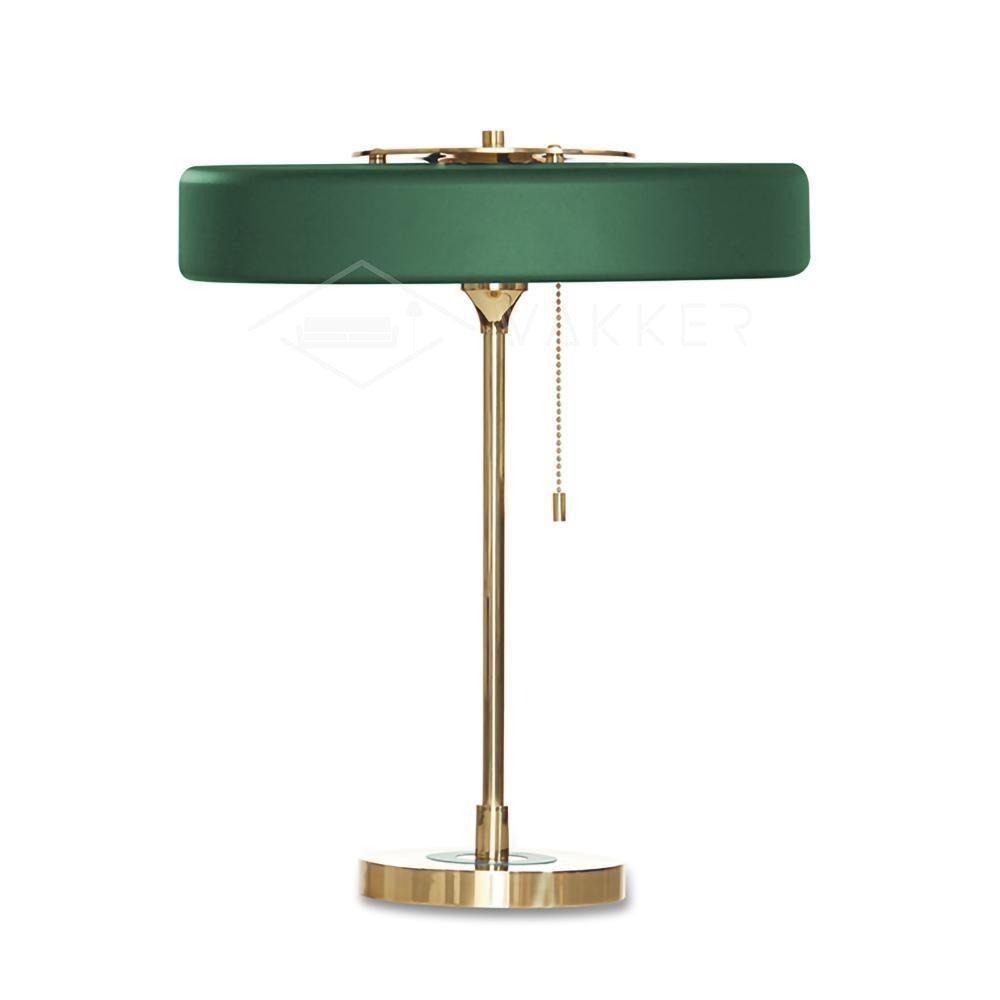 Spun metal table lamp on a wooden surface