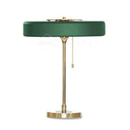Spun metal table lamp on a wooden surface