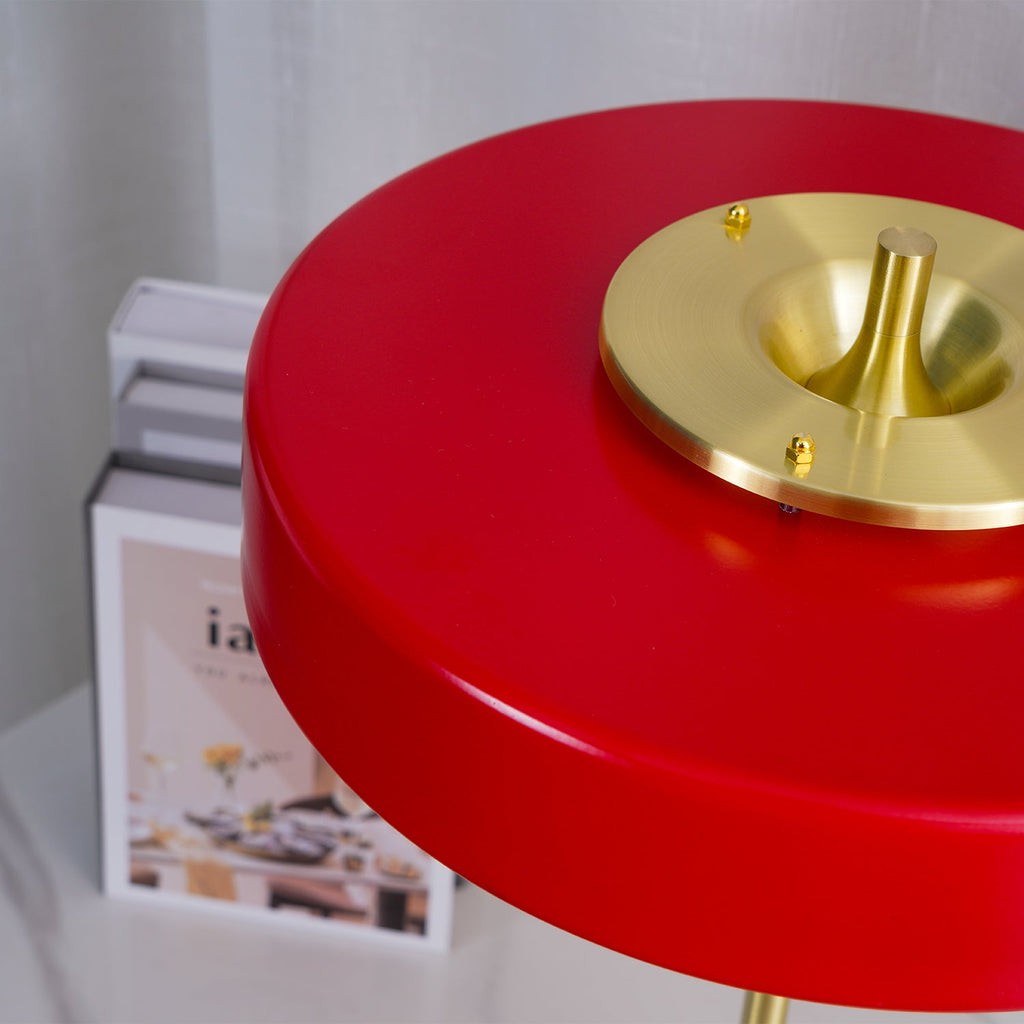 Gold base table lamp glowing on a side table