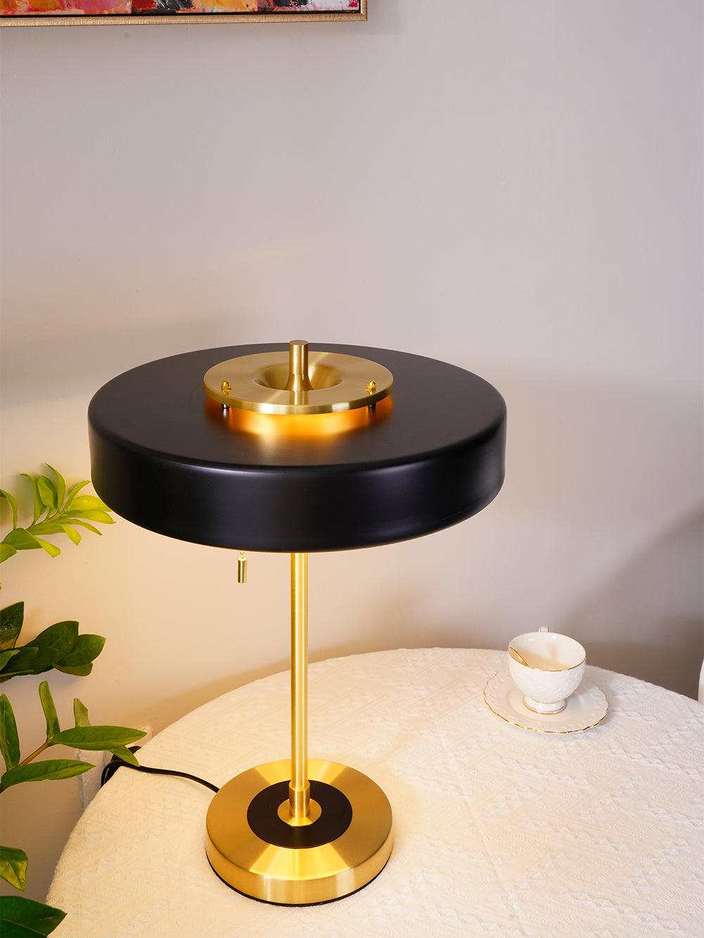 Revolve table lamp glowing in a styled interior