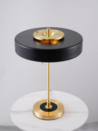 Revolve table lamp with opal diffuser lit softly
