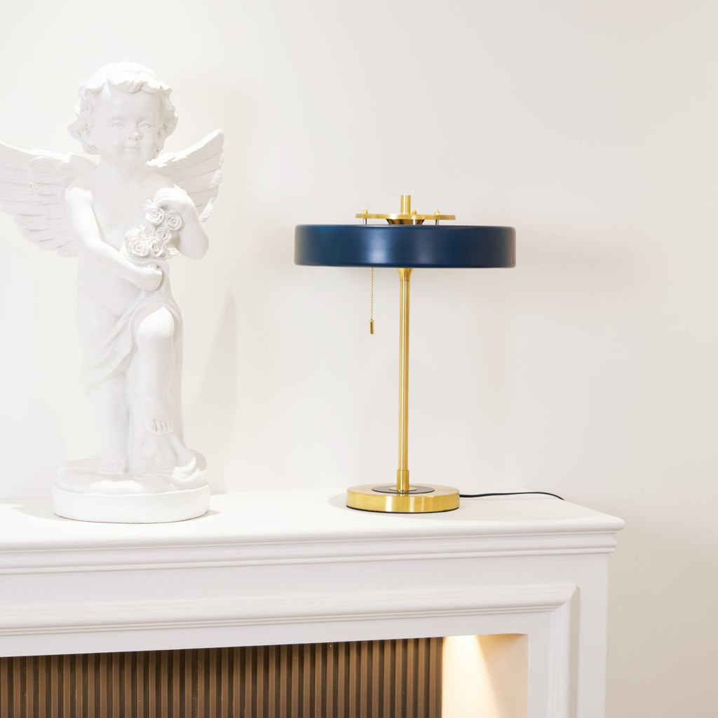 Table lamp with gold base and coloured shade ring