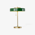 Table lamp with opal diffuser glowing on a desk