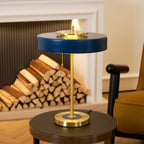 Gold base table lamp glowing through its opal diffuser