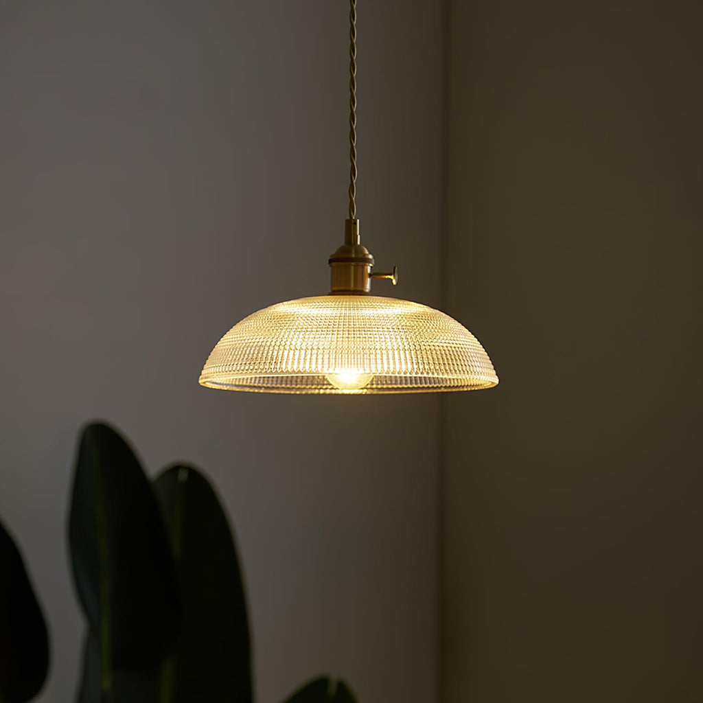 Close view of the lit ribbed glass shade on this Clérachic pendant, its rippled texture catching the light.