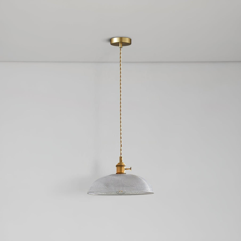 Seen from below, the unlit shade of this Clérachic pendant hangs on a slim brass cord against a white ceiling.