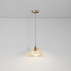 Lit from the same low angle, this Clérachic pendant's ribbed glass shade casts a warm glow across the ceiling.