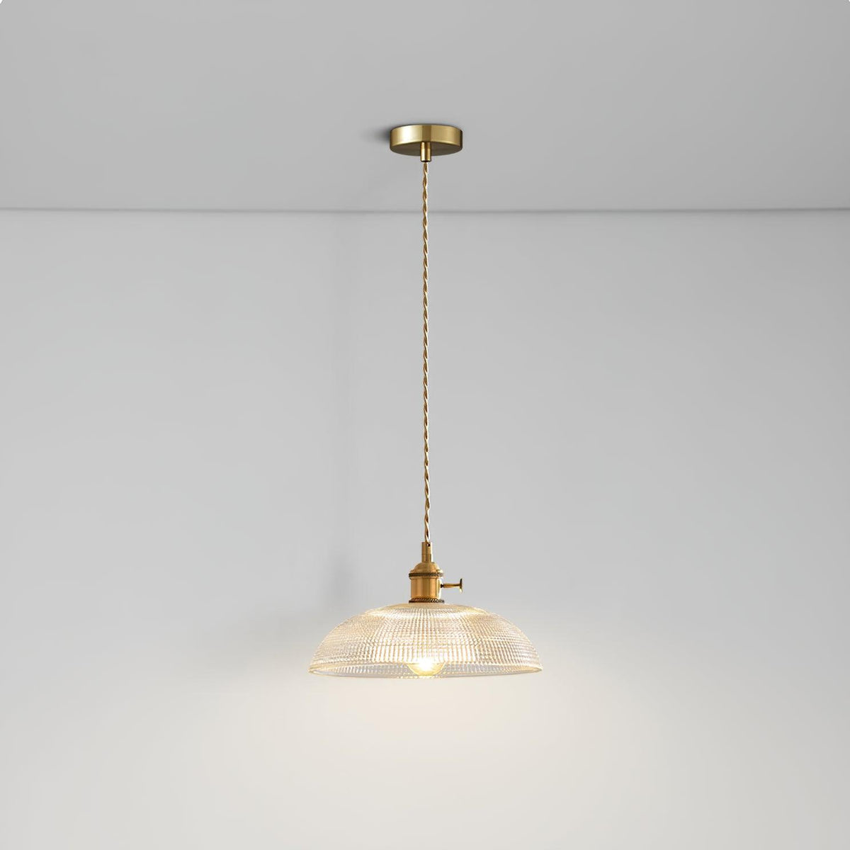 Lit from the same low angle, this Clérachic pendant's ribbed glass shade casts a warm glow across the ceiling.