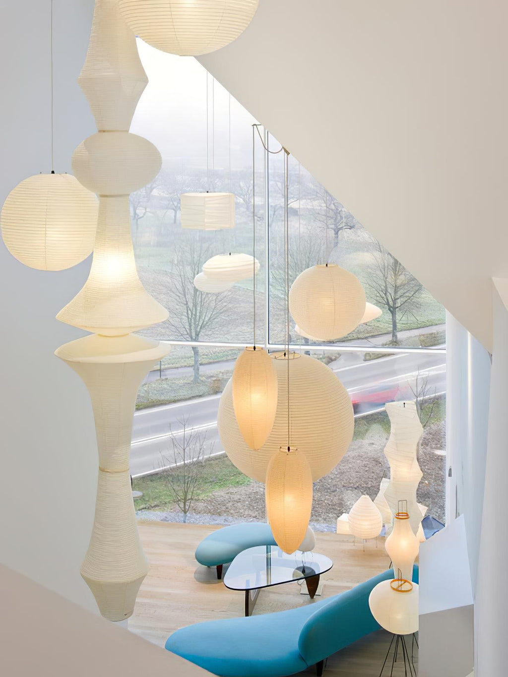 Mulberry paper pendant lit softly above seating