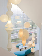 Mulberry paper pendant lit softly above seating