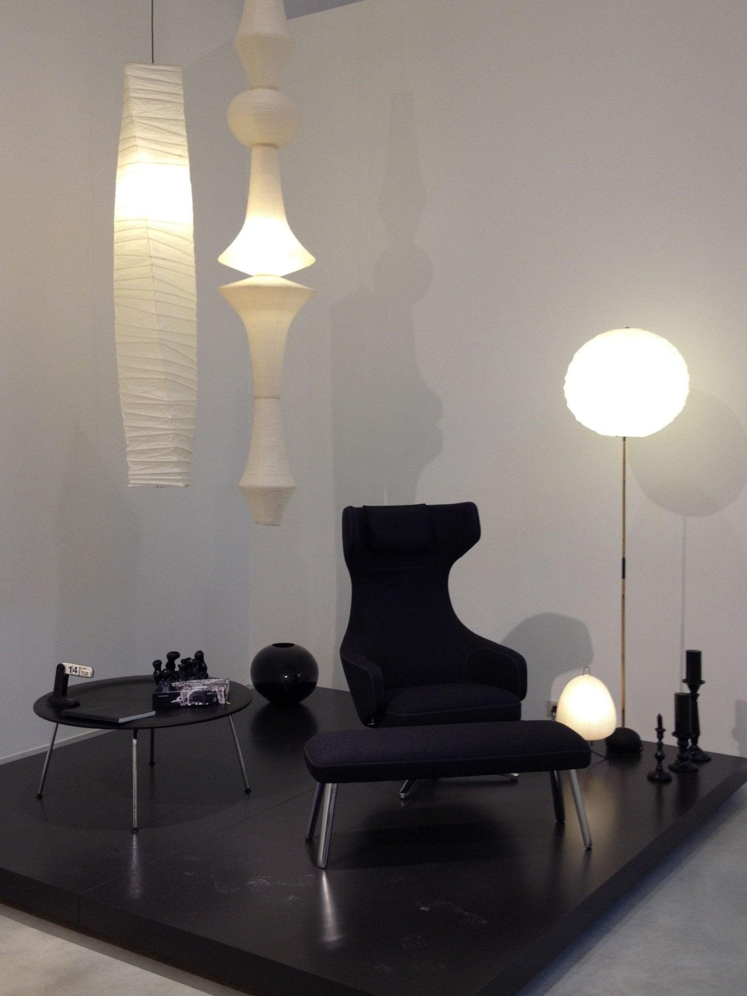 White paper pendant drop glowing in a tall space