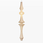 Tall mulberry paper pendant glowing in an entryway