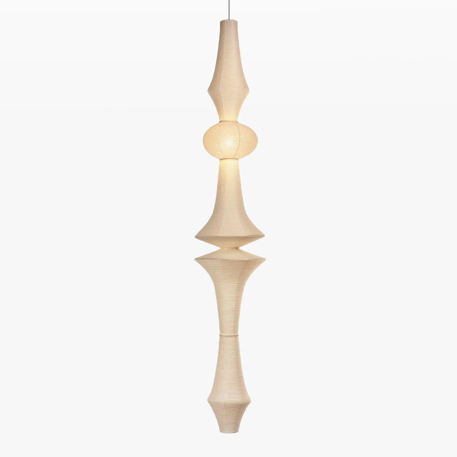 Tall mulberry paper pendant glowing in an entryway