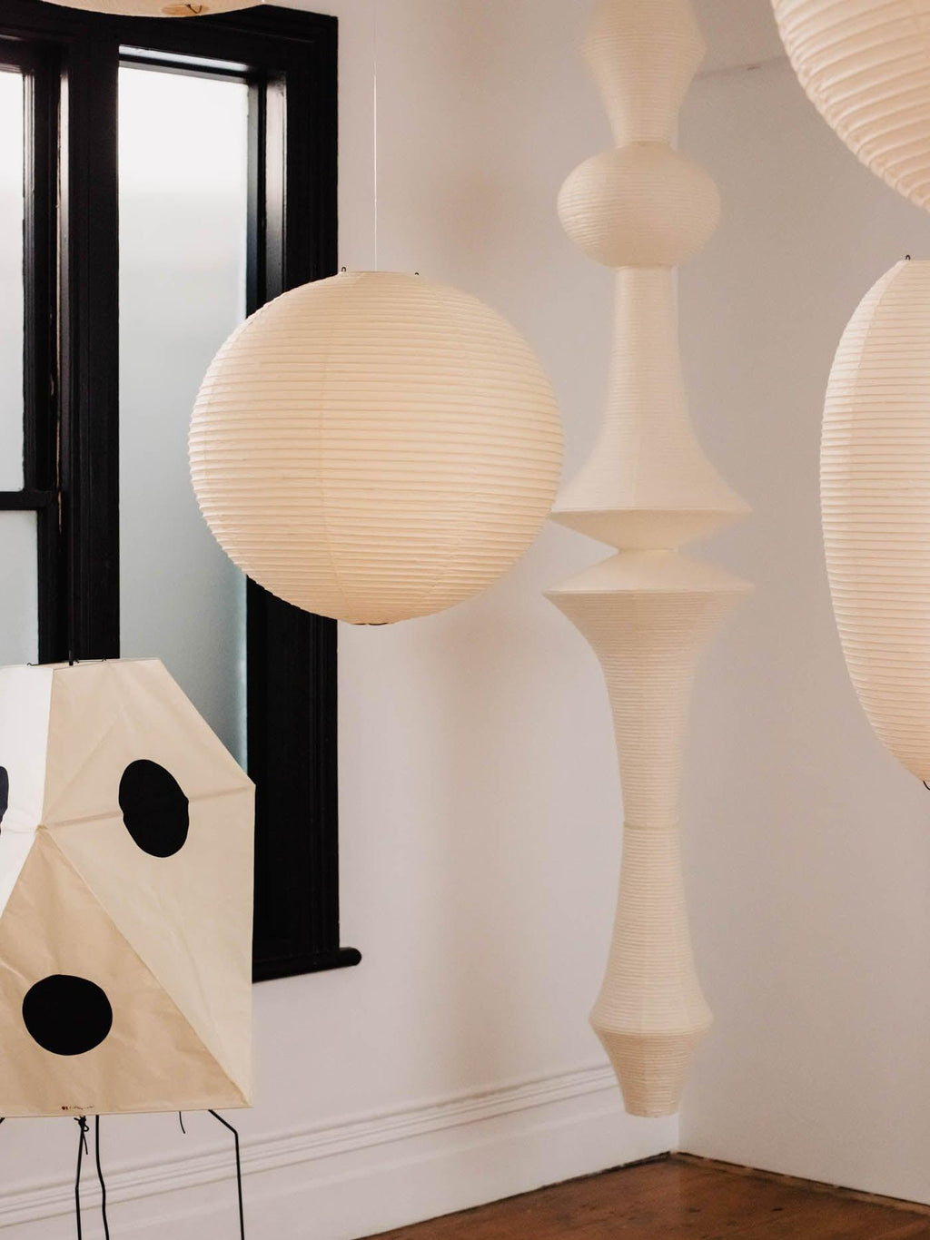 White paper pendant drop glowing beside a staircase