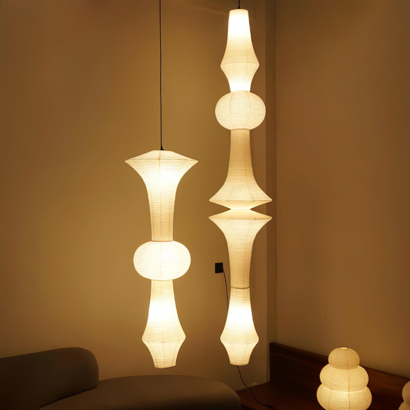 Slender washi paper pendant glowing over a room