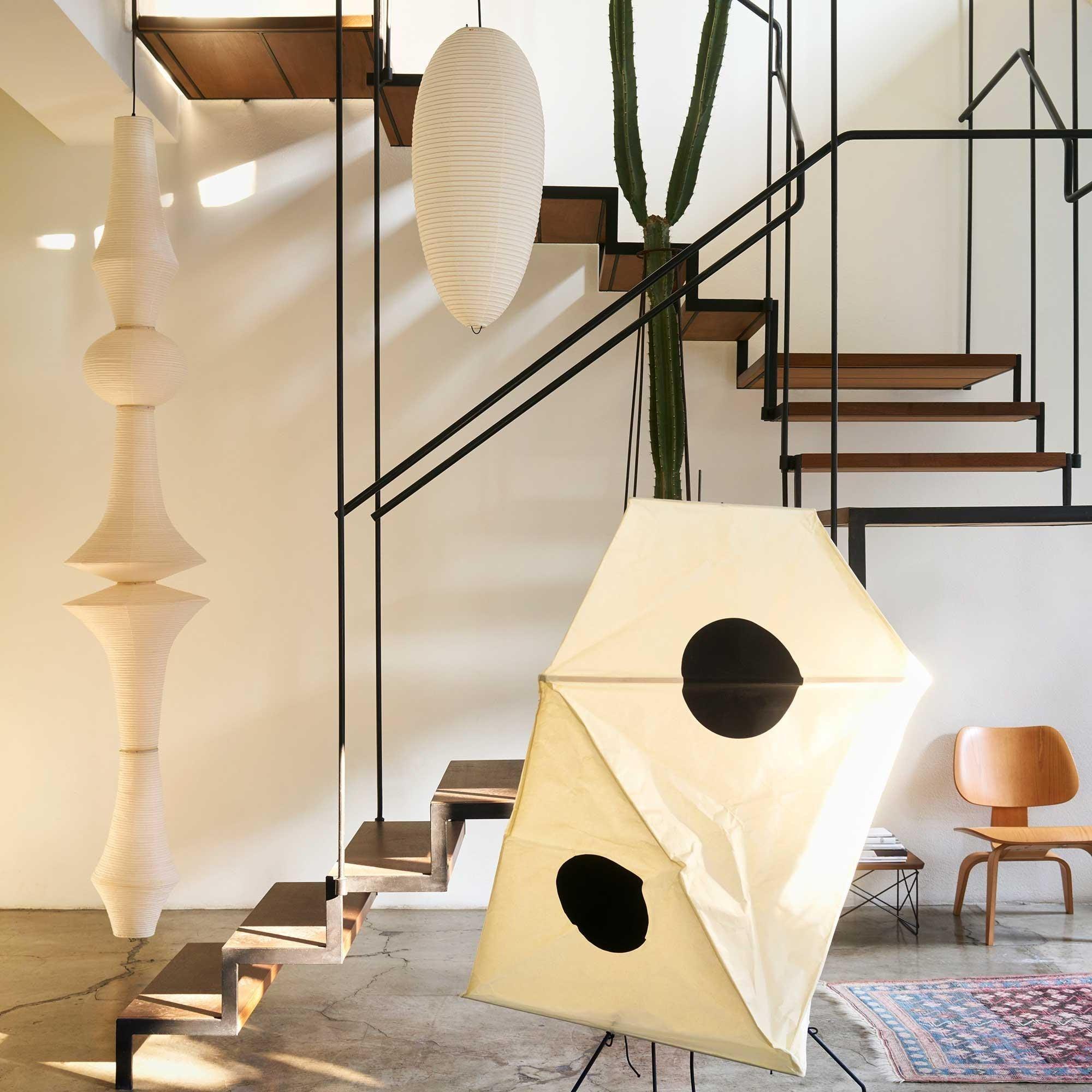 Tall washi paper pendant styled in a double-height space