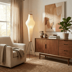 Tall white paper floor lamp beside a low chair and plant