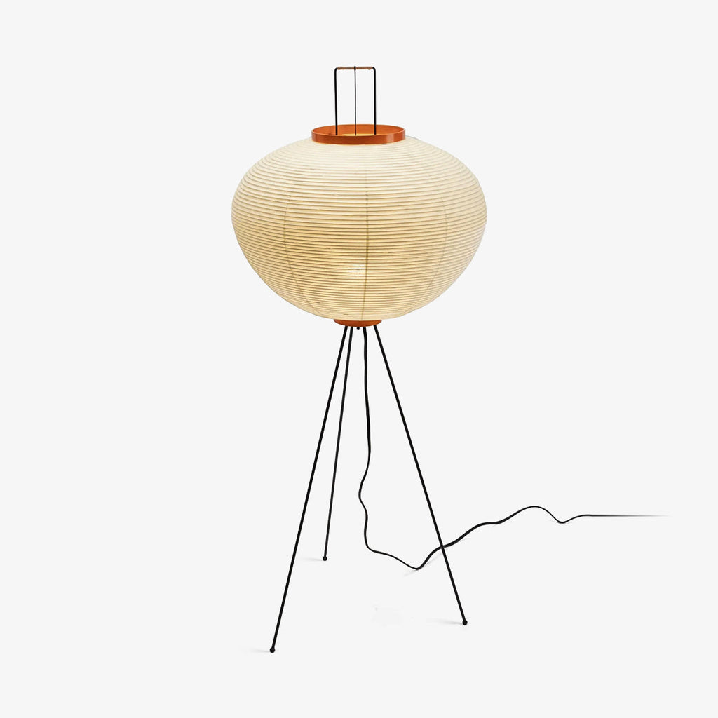 Akari floor lamp casting warm diffused light beside a sofa
