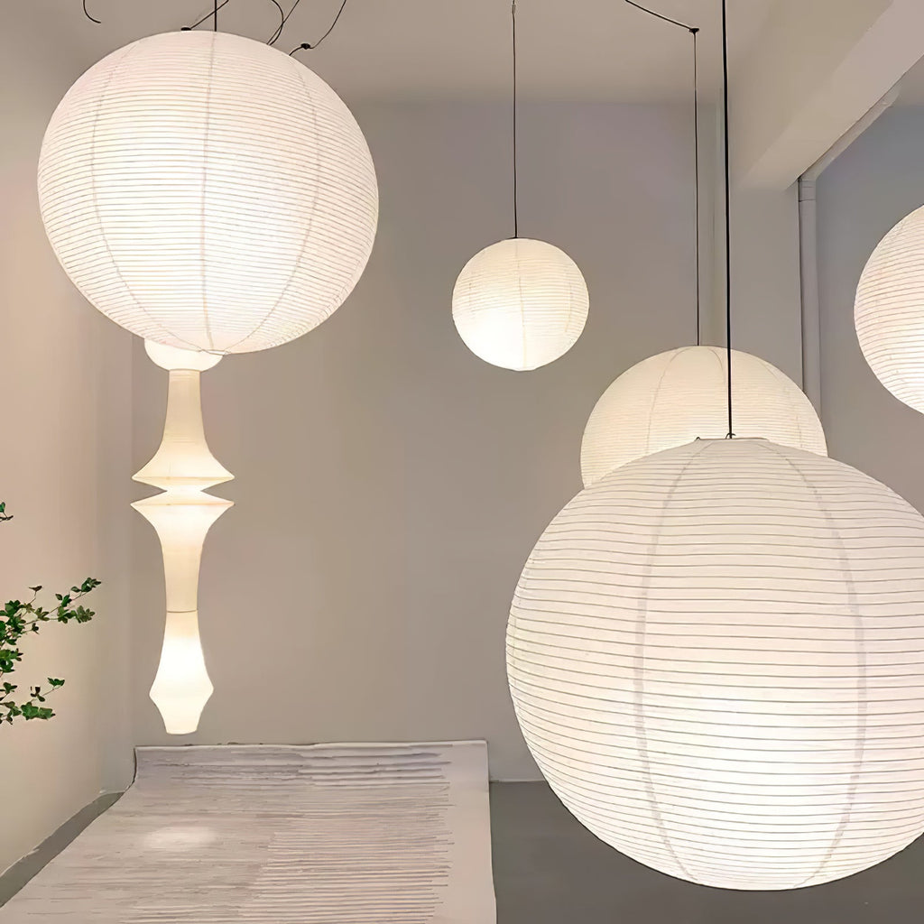 White paper pendant lamps grouped over a table