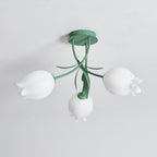 On a plain background, this Clérachic ceiling light in green is shown unlit with its three shades evenly spaced.