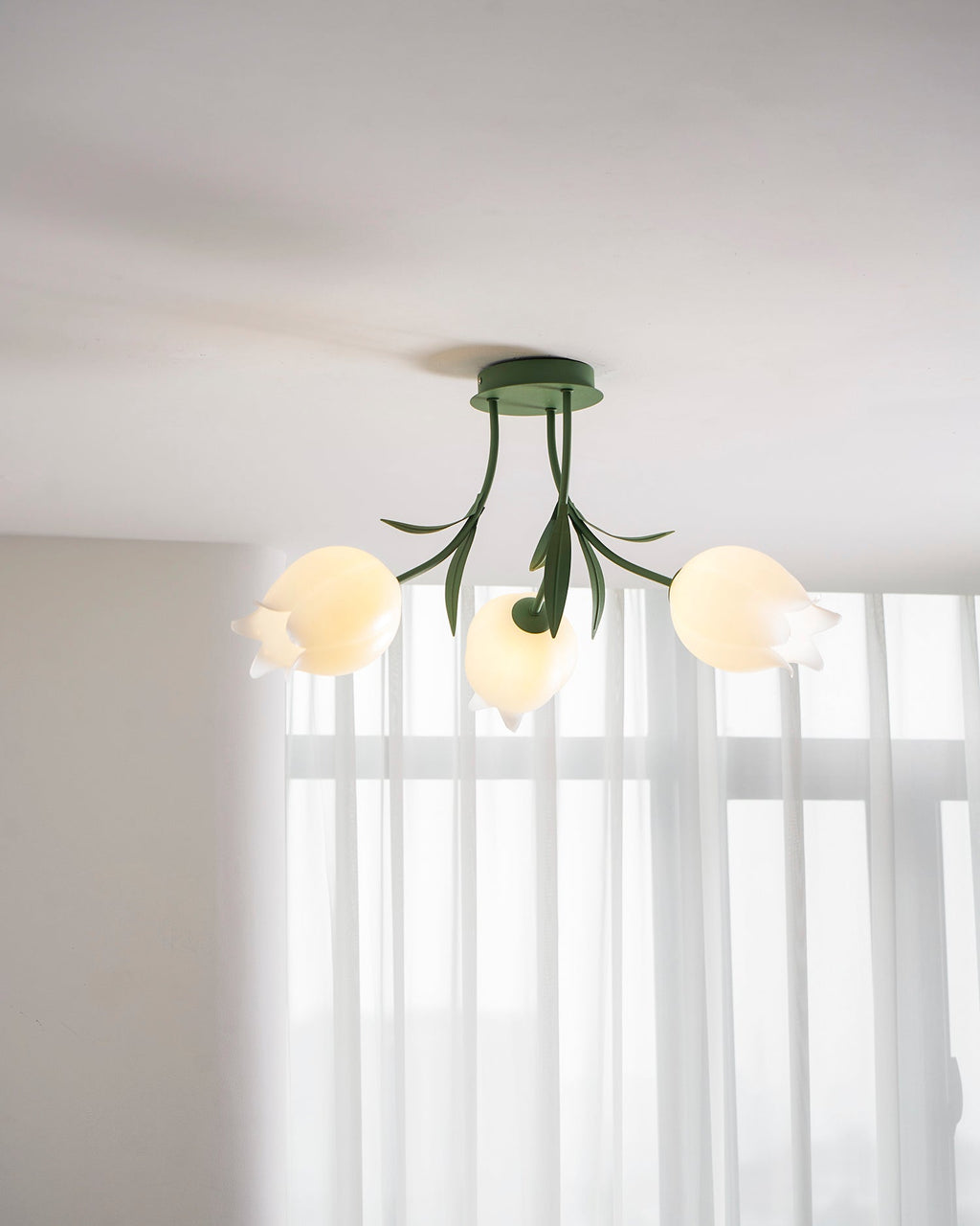 Near a sheer-curtained window, this Clérachic ceiling light in green is shown from a slightly different crop.