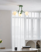 Glowing warm against bright window light, this Clérachic ceiling light in green hangs in a dining space with sheer curtains.