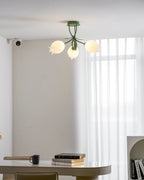 Above a dining table, this Clérachic ceiling light in green hangs unlit, its three shades shown in a wider view.