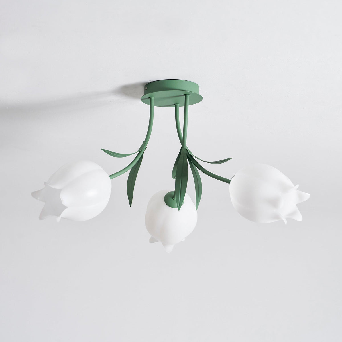 Shown on a plain background from a slightly different unlit angle, this Clérachic ceiling light in green hangs still.