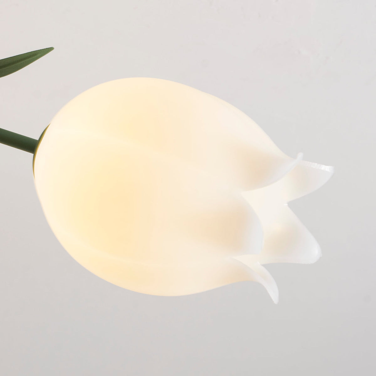 Close view of the ruffled, hand-cut edge on one acrylic shade of this Clérachic ceiling light.