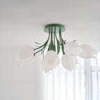 Near a sheer curtain, this Clérachic ceiling light in green hangs unlit, its full cluster of shades seen from below.