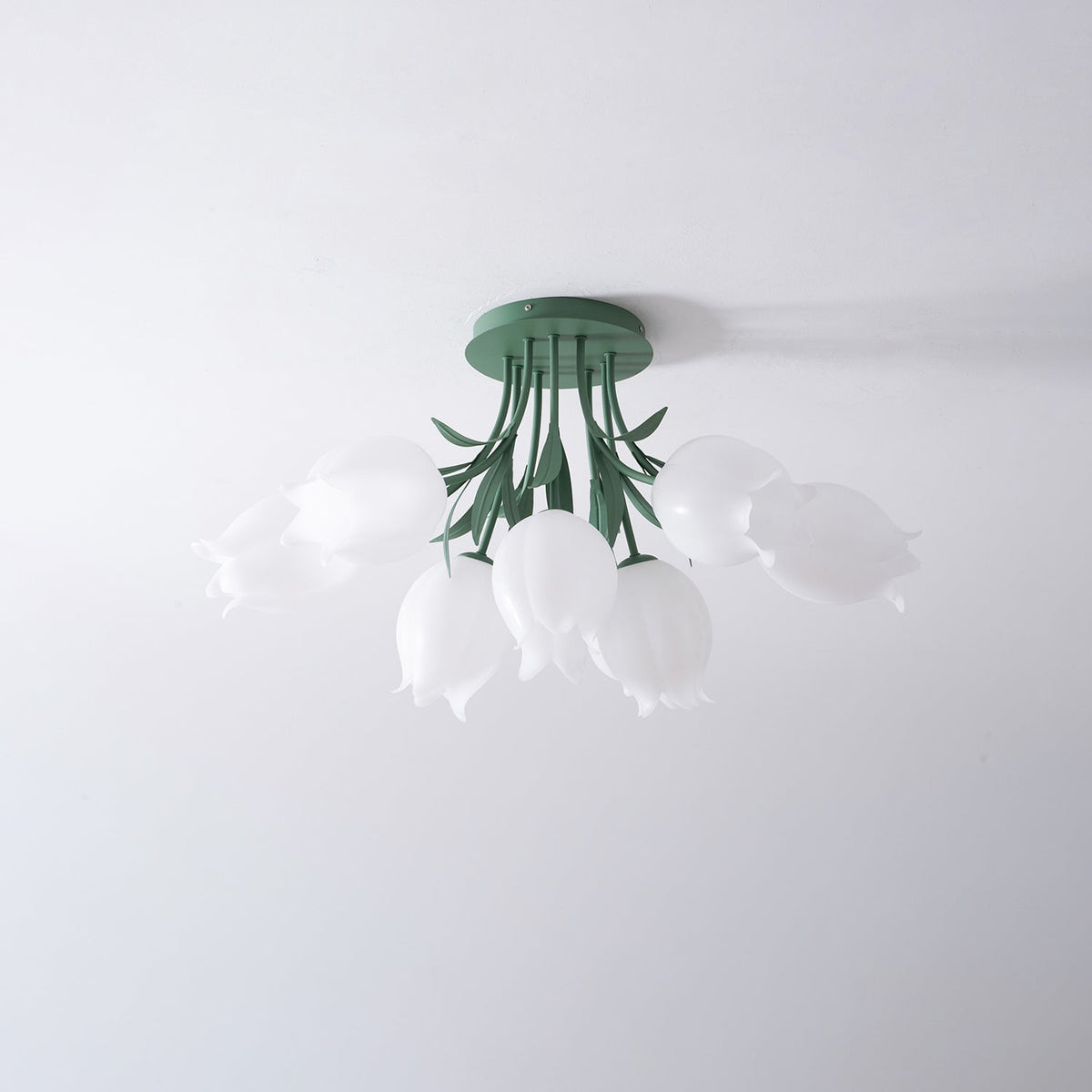 On a plain grey background, this Clérachic ceiling light in green is shown unlit from a front-angled view.