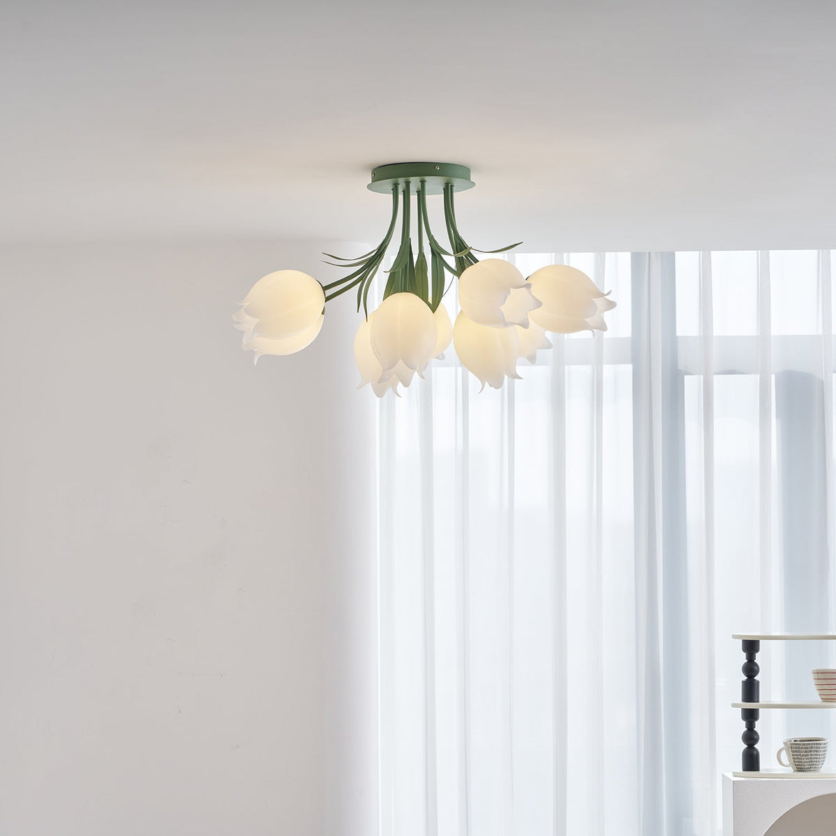Near a sheer curtain, this Clérachic ceiling light in green is framed slightly differently than a previous view.