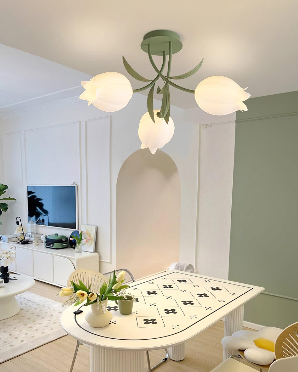 Mounted high above a room with an arched niche, this Clérachic ceiling light in green hangs over a patterned dining table.