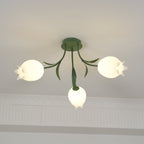 Hanging near a cove moulding, this Clérachic ceiling light in green shows its stem and leaves above the shades.