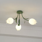 Beneath a cove moulding, this Clérachic ceiling light in green glows softly, its three shades lit warm.