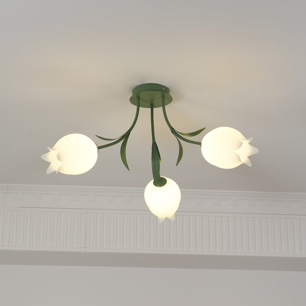 Framed slightly wider than a previous view, this three-shade Clérachic ceiling light in green hangs near a cove moulding.