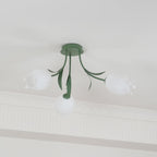 Beneath a cove moulding, this Clérachic ceiling light in green is mounted with its three shades unlit against a plain ceiling.