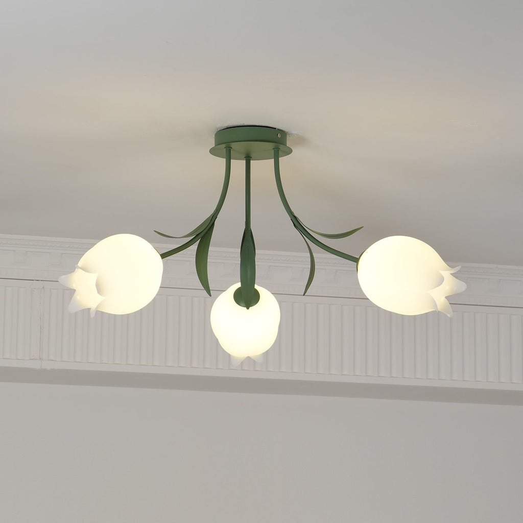 Glowing warm beneath a cove moulding, this Clérachic ceiling light in green has all three shades lit at once.