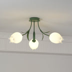 Glowing warm beneath a cove moulding, this Clérachic ceiling light in green has all three shades lit at once.