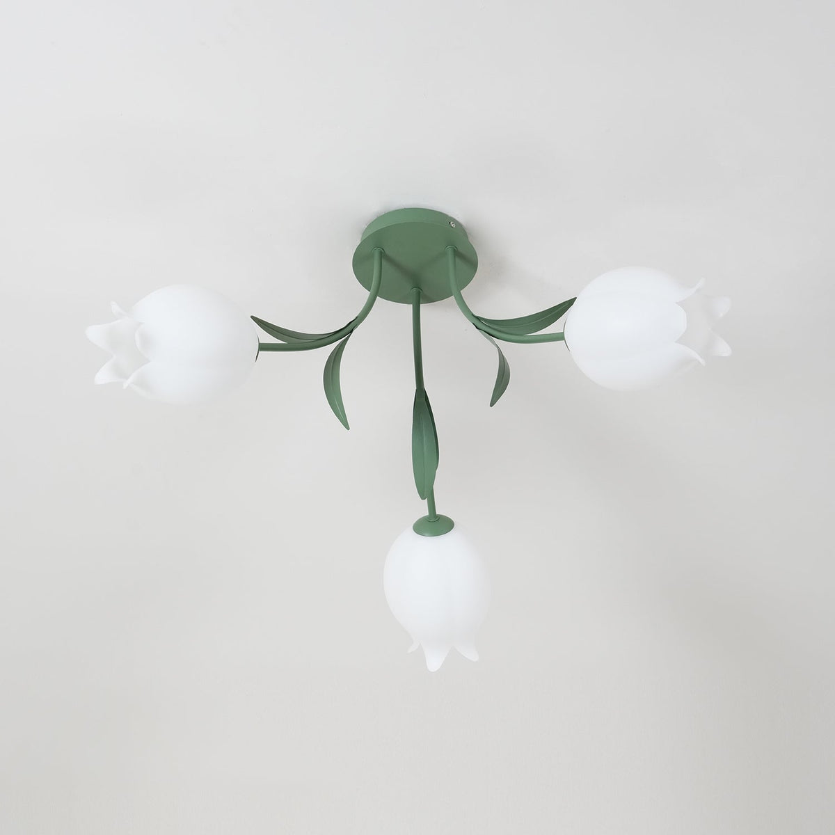 Seen from the side near a cove moulding, this Clérachic ceiling light in green shows two shades clearly.