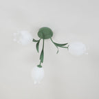 Near a cove moulding, this Clérachic ceiling light in green hangs unlit, seen from a slightly different side angle.