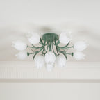 Near a cove moulding, this Clérachic ceiling light in green shows its cluster of shades softly lit from within.