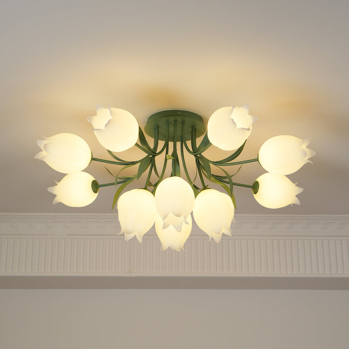 Beneath a cove moulding, this Clérachic ceiling light in green glows, seen from a slightly different angle than before.
