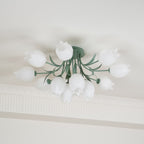 Near a cove moulding, this Clérachic ceiling light in green hangs with its full cluster of shades unlit in daylight.