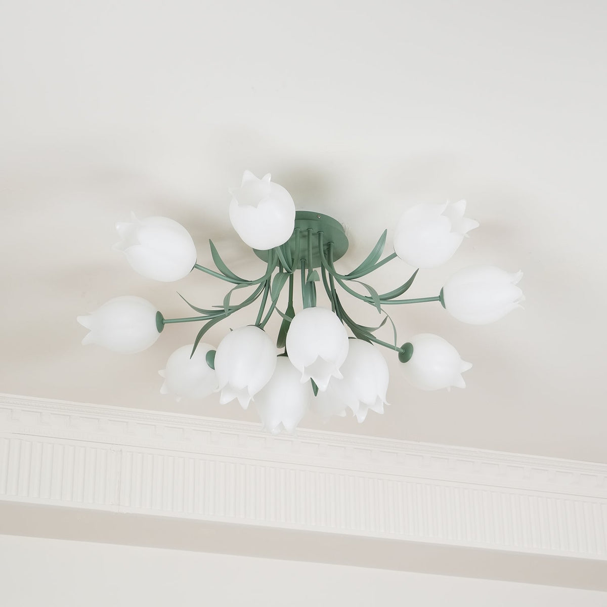 Near a cove moulding, this Clérachic ceiling light in green shows its cluster softly out of focus at the edges.