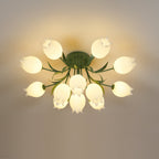 Against a plain grey-beige background, this Clérachic ceiling light in green glows warm with its full cluster lit softly.