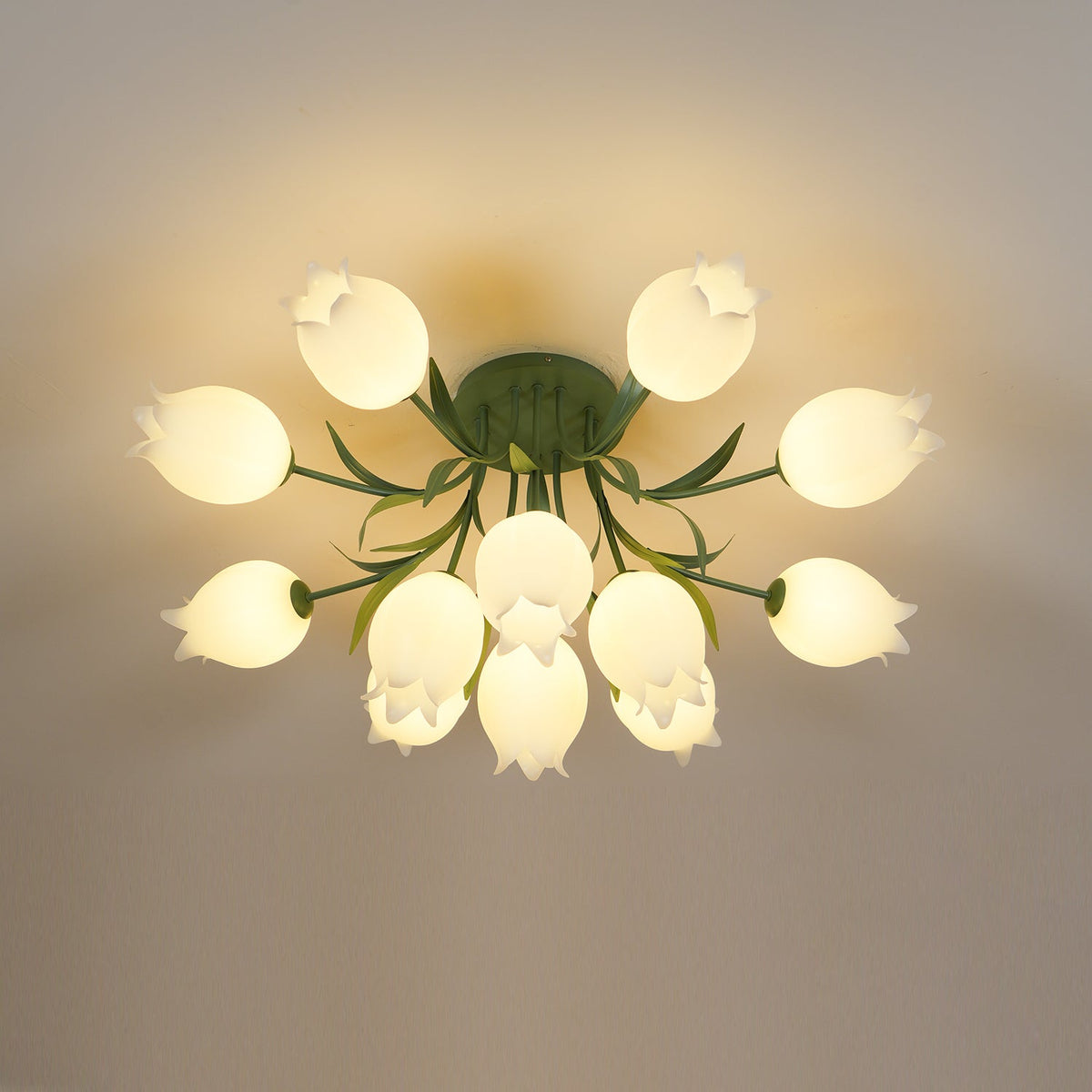 Against a plain grey-beige background, this Clérachic ceiling light in green glows warm with its full cluster lit softly.
