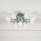 Shown close beneath a cove moulding, this Clérachic ceiling light in green has its cluster of shades unlit.