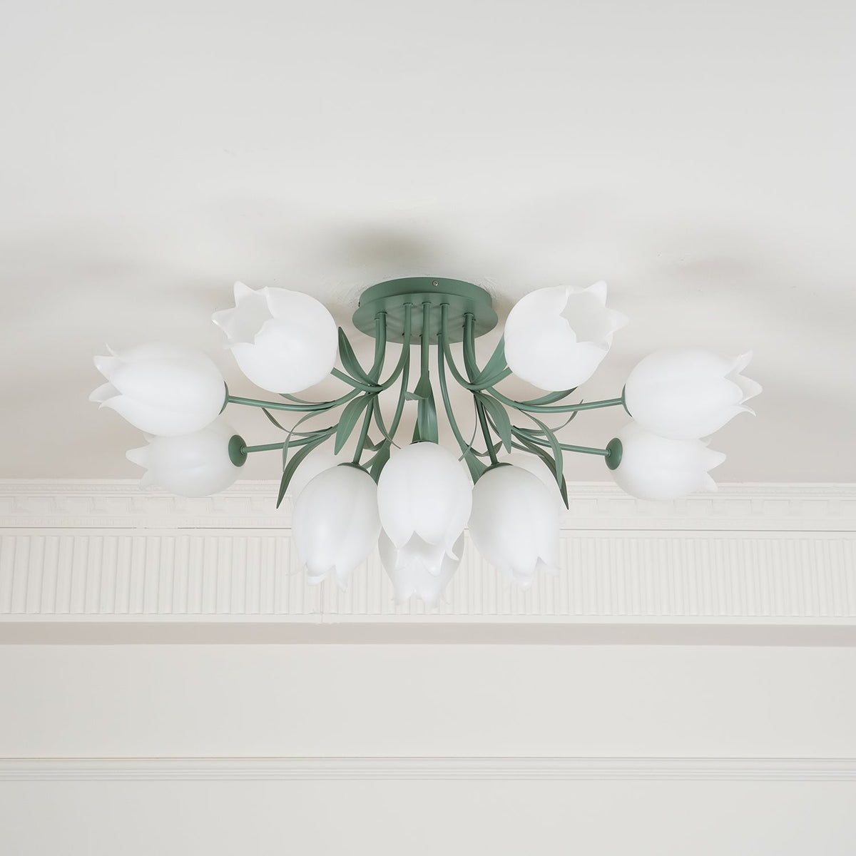 Shown close beneath a cove moulding, this Clérachic ceiling light in green has its cluster of shades unlit.