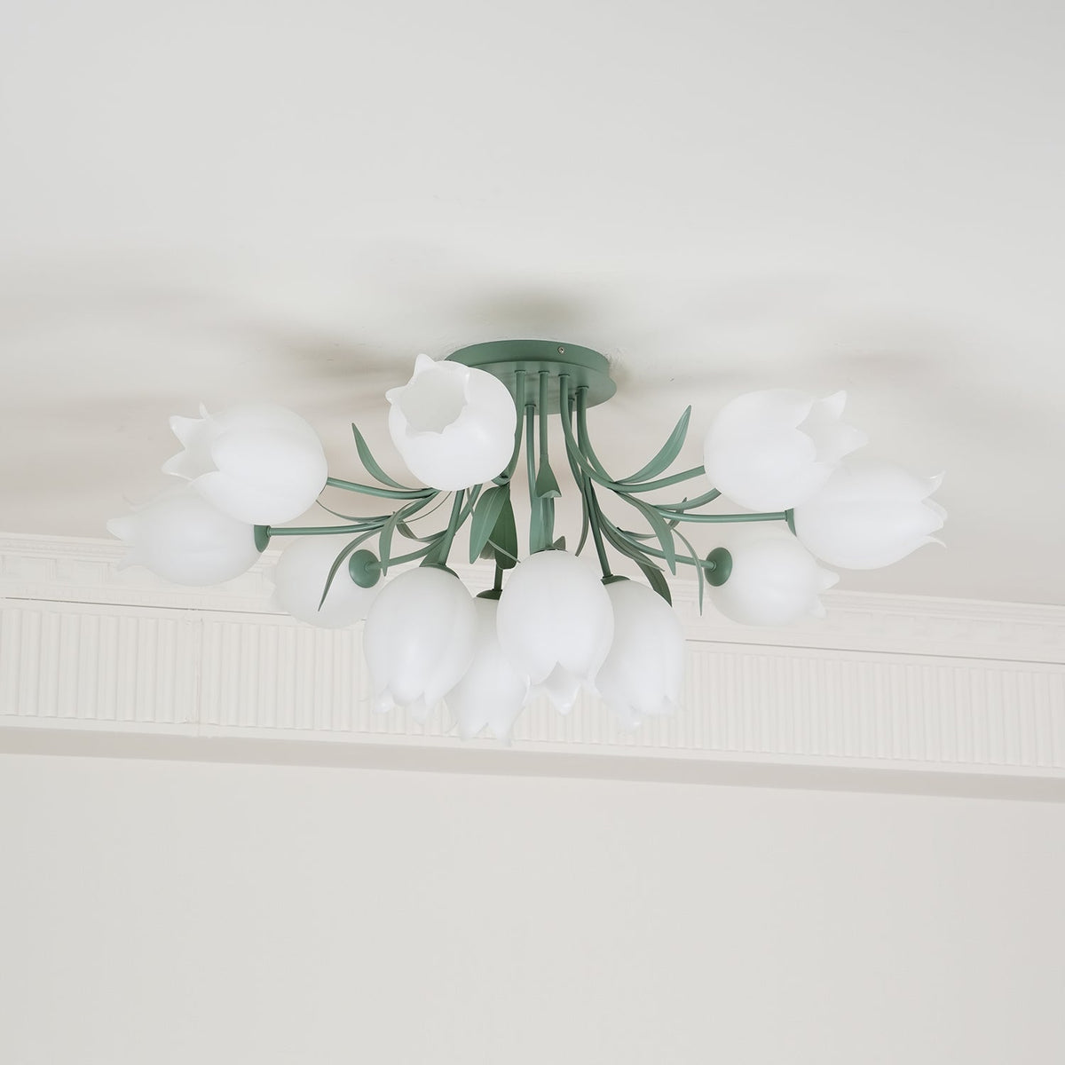 Partly cropped in this view, this Clérachic ceiling light in green shows a portion of its unlit cluster of shades.